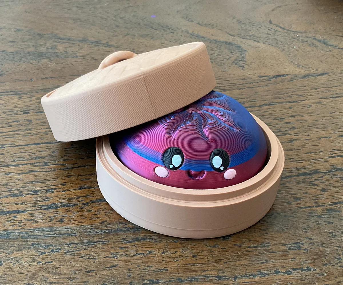 Colorful 3D printed Dumpling Clicker resting inside its round case