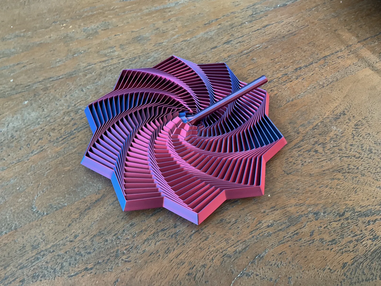 Red and blue Fidget Star folded into a rippling spiral