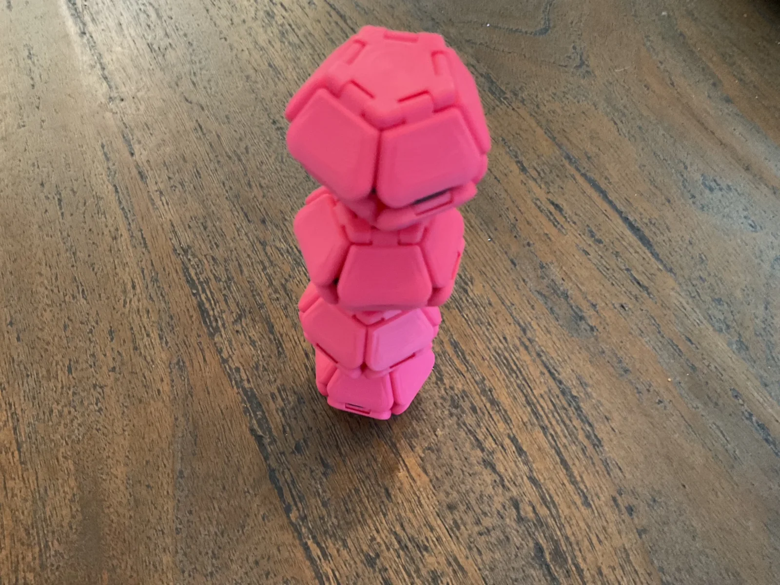 Pink Pentaclicks folded into a tall twisting stack